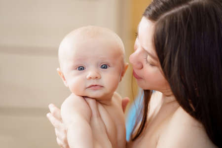 beautiful and gentle naked mom and baby