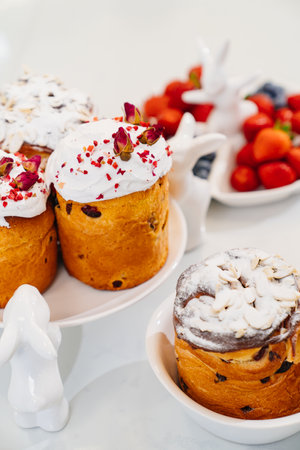decorated panettones and cruffins on serving plates with rabbits. easter cakes.の写真素材