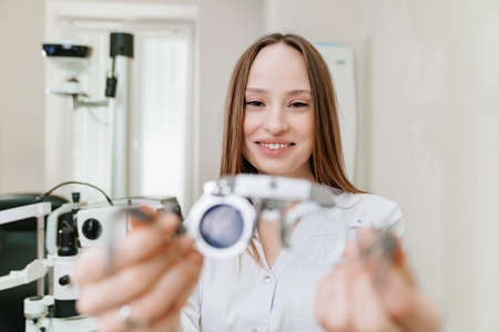 ophthalmologist with trial frame for selection of glasses. selective focusの写真素材