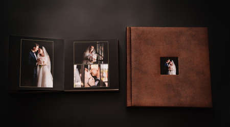wedding photobooks in brown leather binding with photos on the coverの写真素材