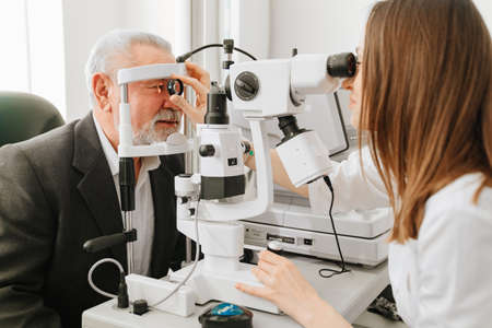 ophthalmologist examination of elderly man with slit lamp. medical equipmentの写真素材