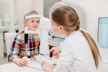 ophthalmologist examines the girl on a corneo topographer. modern clinic.の写真素材