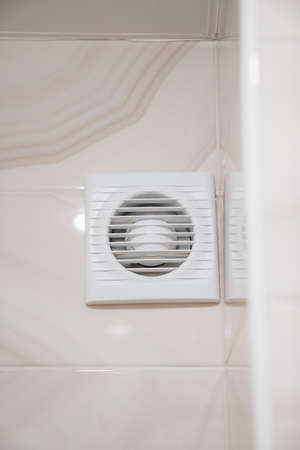 fan grille on the wall in the bathroom. ventilation and air conditioning systemの写真素材