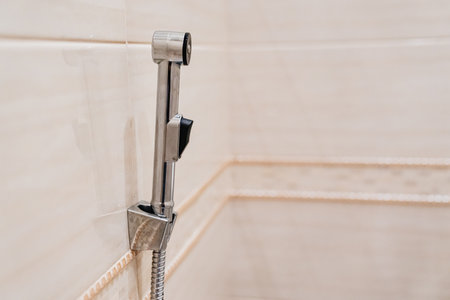 hygienic shower on the wall in the toilet.の写真素材