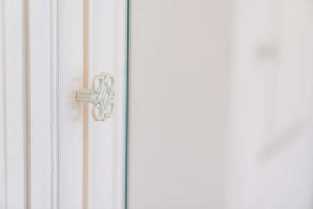 carved retro metal handles on the doors of the wardrobe.の写真素材