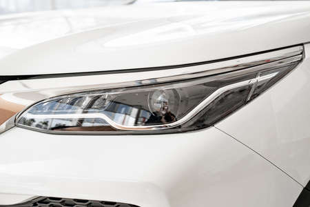 the headlight on the white car. official dealerships and auto shops.