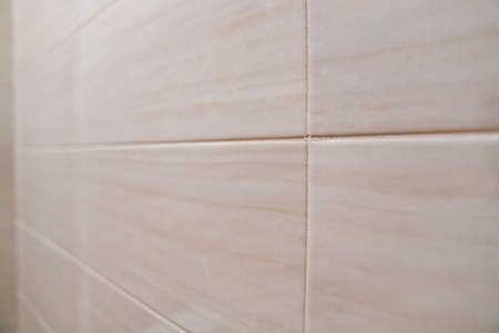 beige ceramic tiles on the wall. materials for renovation in the house.の写真素材