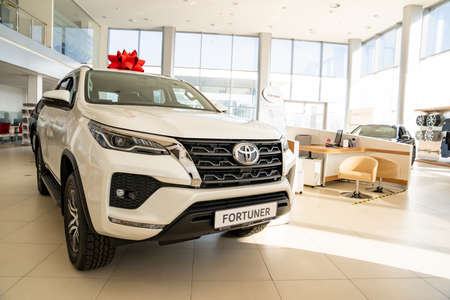 new white car Toyota fortuner with red gift bow on the roofのeditorial素材