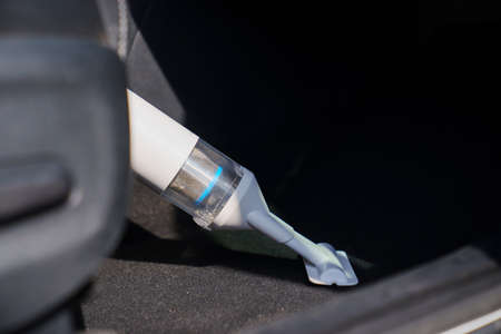 self-service car wash. person vacuuming car cabin after washingの写真素材