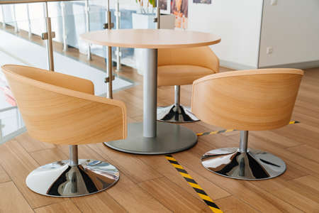 office furniture. round table and chairs made of wood on a metal leg.の写真素材