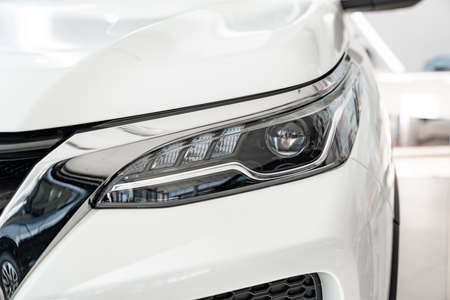 the headlight on the white car. official dealerships and auto shops.