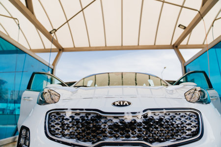 wet white kia car. self-service car wash. car washer.のeditorial素材