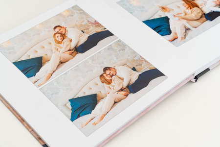 a book with photos of big family at home on a white background.の写真素材