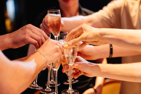 hands with glasses of champagne at the banquet. traditional toasts on holidays.