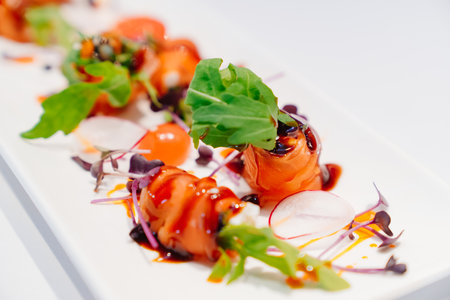 a plate with beautifully served trout rolls. fish delicaciesの写真素材