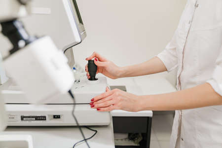 doctor examines eyes on screen of autorefractometer.の写真素材