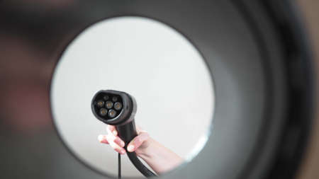 plugging in an electric car at outlet socket.の写真素材