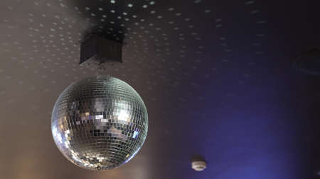rotating disco ball on the ceiling of the roomの写真素材