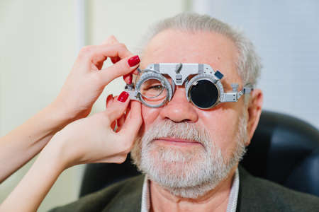 making selection of lenses, diagnosing a elderly mans vision.の写真素材