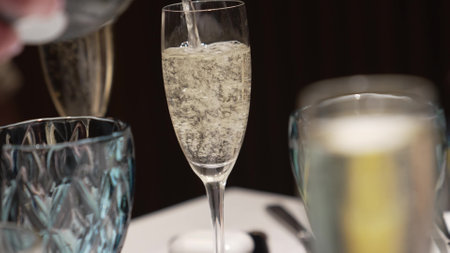 The waiter pours the champagne martinis into the glasses.のeditorial素材