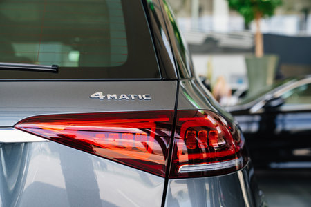 tail light of a grey Mercedes 4matic car in the parking of a car dealershipのeditorial素材