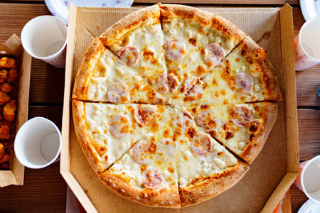 a piece of pizza out of the box.