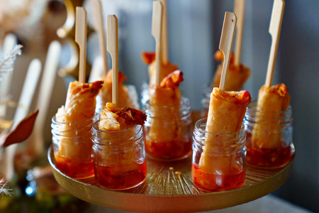 small glass jars with sauce and shrimp in the dough. catering services.
