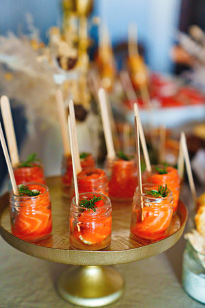small glass jars with red salted fish. catering services for the party.