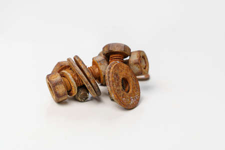 Rusty metal bolts and screws on a white background.の写真素材