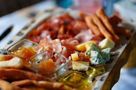 delicious snacks. meat, cheese, sauces and sandwiches with pate and vegetables.のeditorial素材