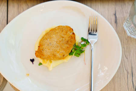 the cutlet in a bowl of mashed potatoes.