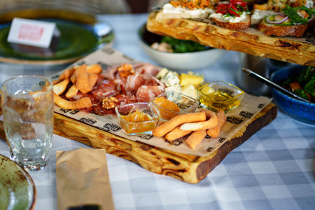 delicious snacks. meat, cheese, sauces and sandwiches with pate and vegetables.のeditorial素材