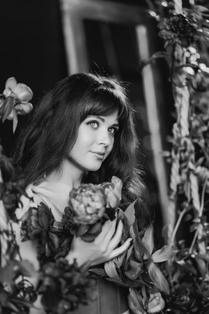 fabulous. a beautiful and gentle woman in peony flowers. black-and-whiteの写真素材