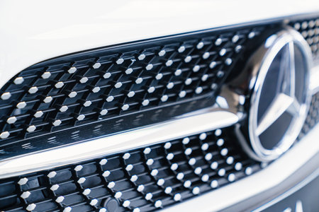 logo and grille radiator. part of a white Mercedes car.のeditorial素材