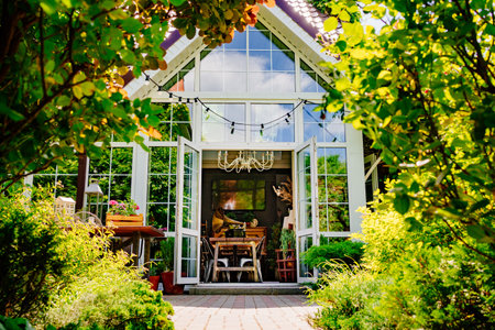 beautiful house with large panoramic windows surrounded by greenery.の写真素材
