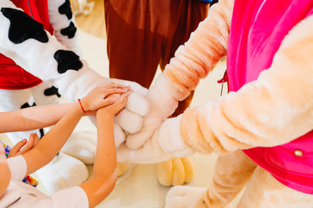hands. team game of Kids and artists in stage costumes at a childrens holiday.の写真素材
