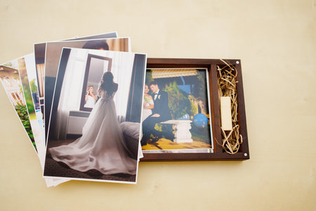 printed wedding photos and a wooden box with a flash drive.の写真素材