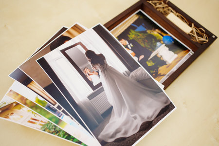 printed wedding photos and a wooden box with a flash drive.の写真素材