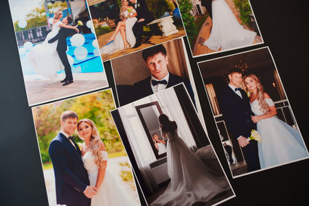 printed wedding photos on a black background.の写真素材