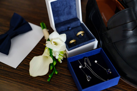 wedding mens shoes, bow tie, wedding rings, costume jewellery and boutonniere.