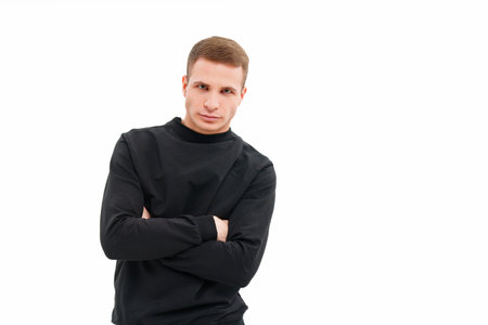 a man in black clothes with his arms crossed on his chest on a white background.