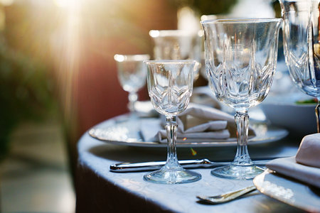 empty wine glasses on the table.table setting for a festive dinner. solar glare.の写真素材