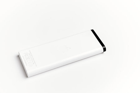 Small remote control for Apple TV on a white background.