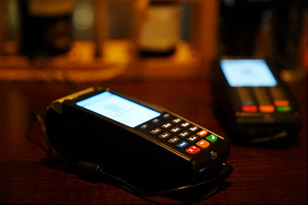 A POS terminal on a table in a dark room.