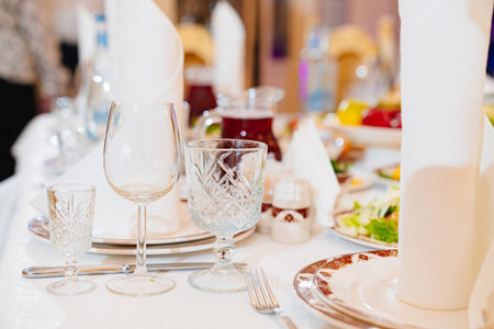 three empty wine glasses on the table. tableware for the banquet.の写真素材