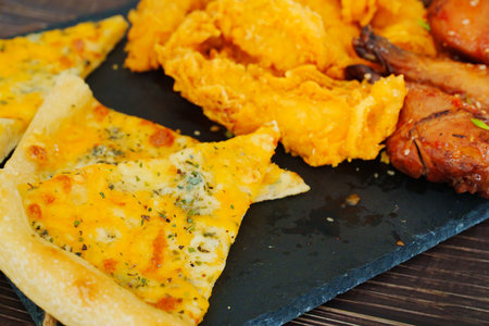 cheese pizza, caramelized chicken with sesame and garlic, meat strips in breadinの写真素材