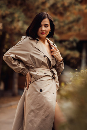 portrait of an attractive brunette in an autumn coat on a city street.の写真素材