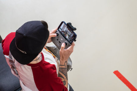 Man Controls Quadcopter for Office Shooting. video shooting of premises.のeditorial素材