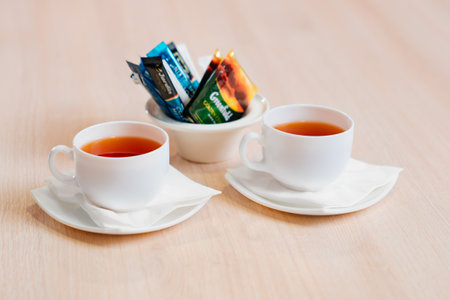 two white cups of tea on the table. the concept of a break at work.のeditorial素材