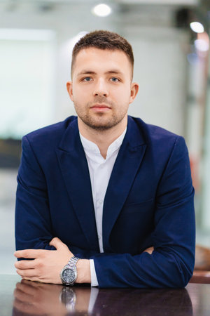 a young attractive man in a blue business suit. the portrait of an entrepreneur.